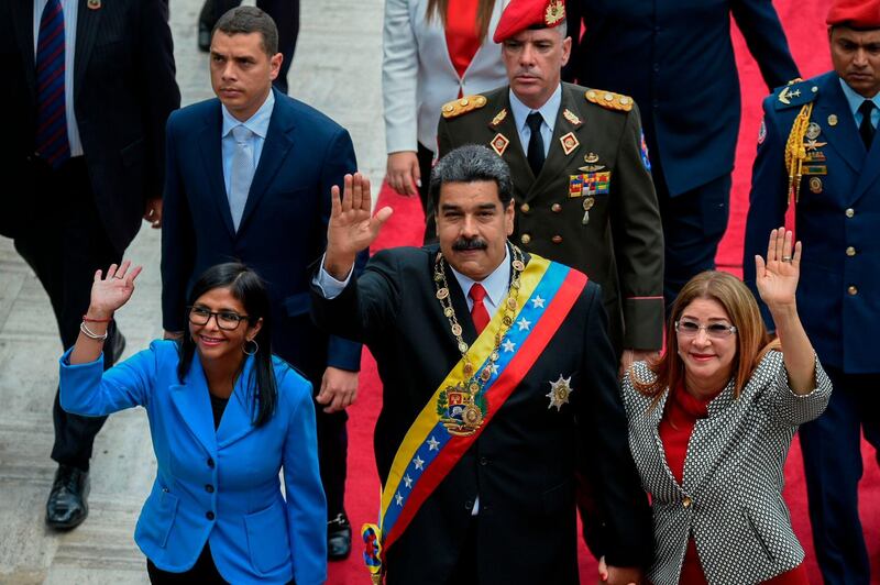 CORRECTION / TOPSHOT - Venezuelan President Nicolas Maduro (C) his wife Cilia Flores (R) and Constituent Assembly president Delcy Rodriguez arrive at the Congress in Caracas for the Presidential inauguration ceremony, on May 24, 2018.   / AFP / Federico Parra                      
