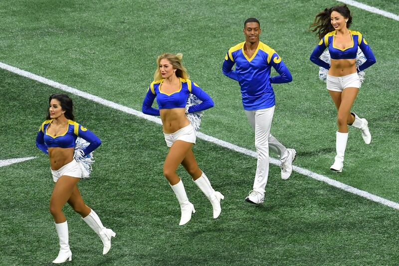 Rams cheerleader Quinton Peron (2nd R) performs with other cheerleaders during Super Bowl LIII between the New England Patriots and the Los Angeles Rams at Mercedes-Benz Stadium in Atlanta, Georgia, on February 3, 2019. (Photo by Angela Weiss / AFP)