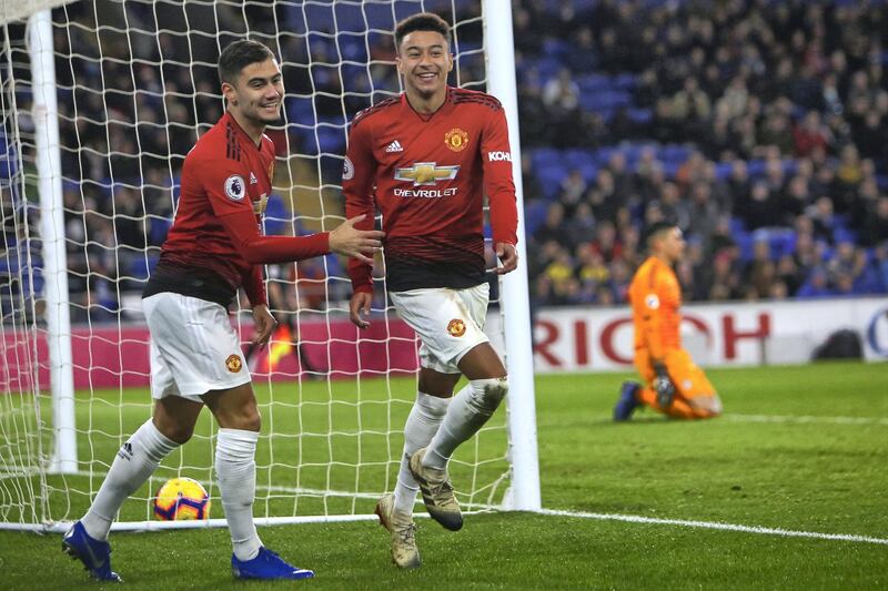 Manchester United's English midfielder Jesse Lingard (C) celebrates with Manchester United's Belgian-born Brazilian midfielder Andreas Pereira (L) after scoring their fifth goal during the English Premier League football match between between Cardiff City and Manchester United at Cardiff City Stadium in Cardiff, south Wales on  December 22, 2018. - Manchester United won the game 5-1. (Photo by Geoff CADDICK / AFP) / RESTRICTED TO EDITORIAL USE. No use with unauthorized audio, video, data, fixture lists, club/league logos or 'live' services. Online in-match use limited to 120 images. An additional 40 images may be used in extra time. No video emulation. Social media in-match use limited to 120 images. An additional 40 images may be used in extra time. No use in betting publications, games or single club/league/player publications. / 