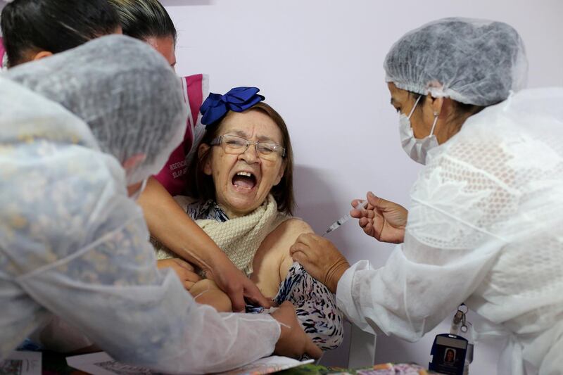 A health worker administers a Covid-19 vaccine to a resident at Solar das Acacias nursing home, in Guarulhos, near Sao Paulo, Brazil. Reuters