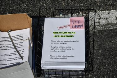 Unemployment forms are distributed at a drive-through collection point outside a library in Florida. US unemployment is rising at a jarring rate as the effects of Covid-19 take hold. AFP