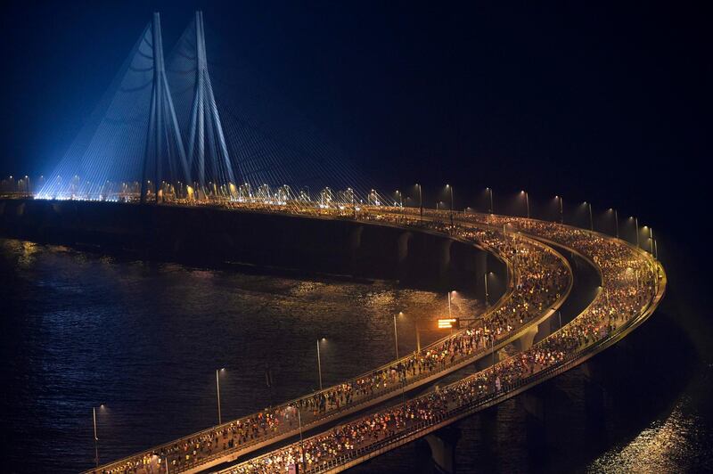 Participants run on Bandra-Worli sea-link bridge during the Tata Mumbai Marathon in Mumbai.  AFP