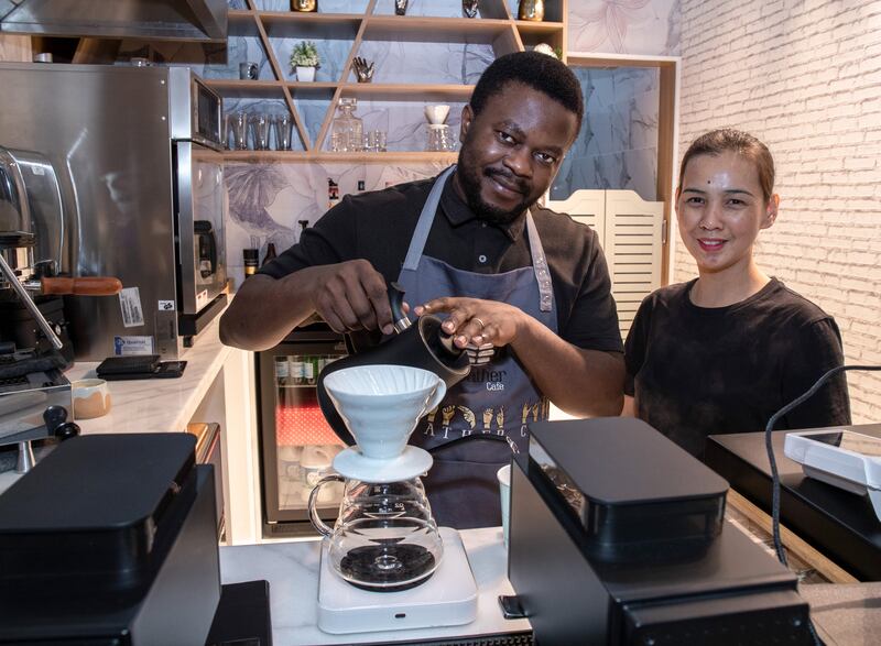 Mae Joaquino, right, and Rene Chi, baristas at To Gather Cafe, a hole-in-the-wall cafe that has recently opened in Meyan Mall. It says it’s the first cafe for deaf people in Dubai. All photos: Victor Besa / The National