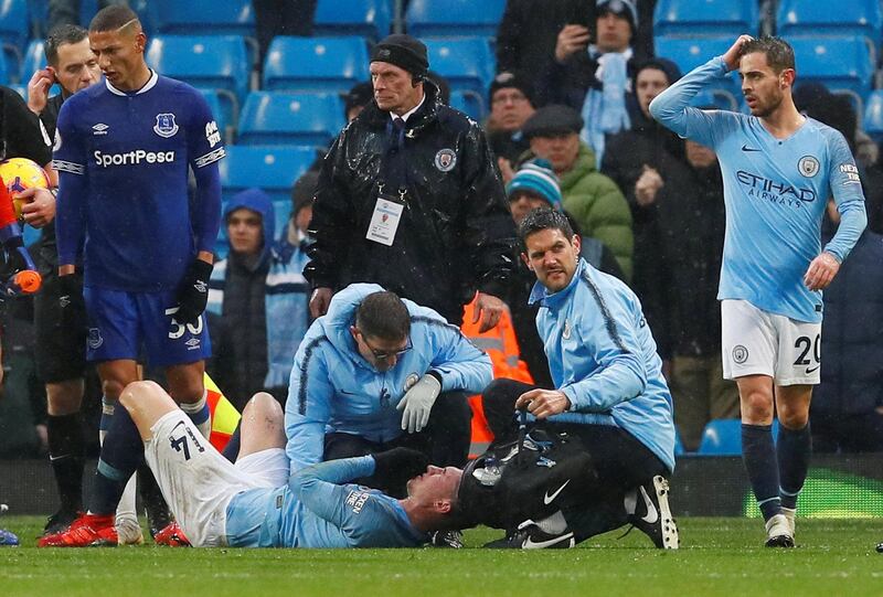 Manchester City's Aymeric Laporte receives medical treatment after sustaining an injury. Reuters