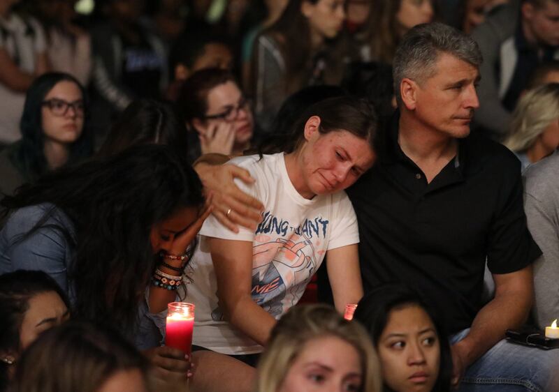 Mourners react during a candlelight vigil at the University of Nevada Las Vegas (UNLV) for victims of the mass shooting in Las Vegas. Eugene Garcia / EPA