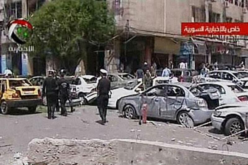 An image grab taken from the state-run Syrian TV shows Syrian police at the scene of a powerful explosion in Marjeh, central Damascus.