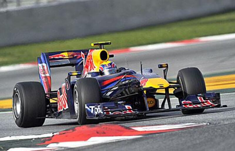 Mark Webber prepares to throw his Red Bull-Renault across the kerbs during testing in Barcelona.