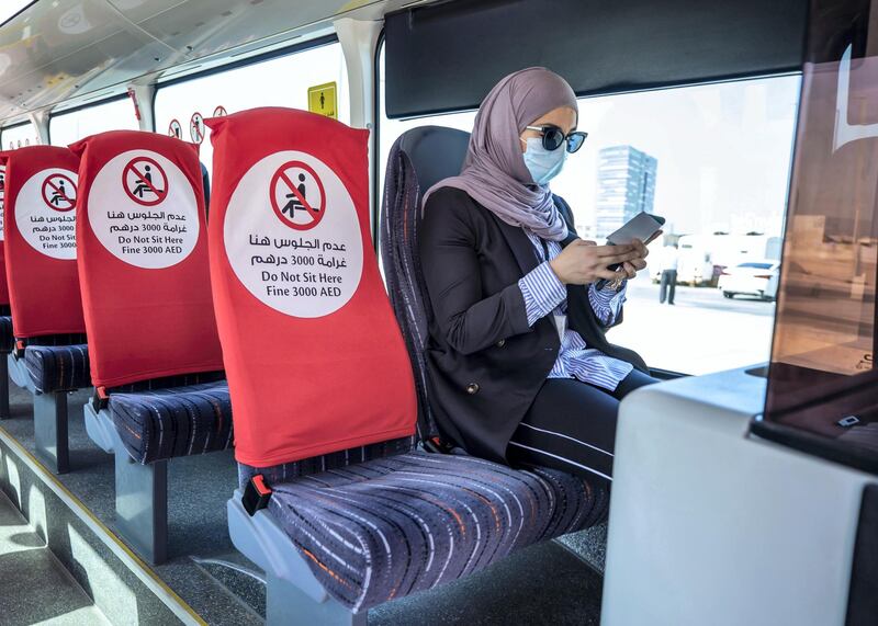 Abu Dhabi, United Arab Emirates, January 20, 2021.  One must collect a "Park and Ride Ticket" from a security guard before entering the bus.
Victor Besa/The National 
Section:  NA
Reporter:  Nilanjana Gupta