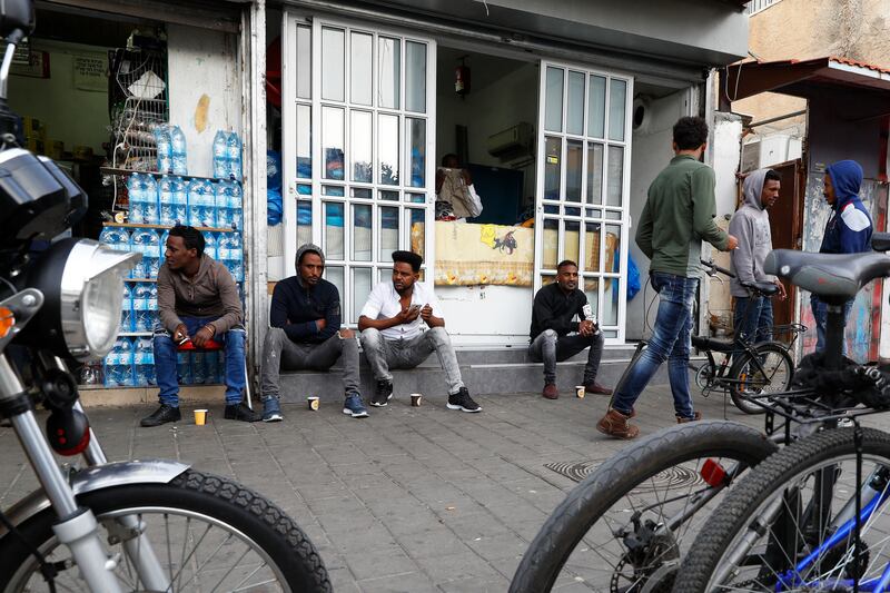 Eritreans sit in a street in southern Tel Aviv in April, 2018. Photo: AFP