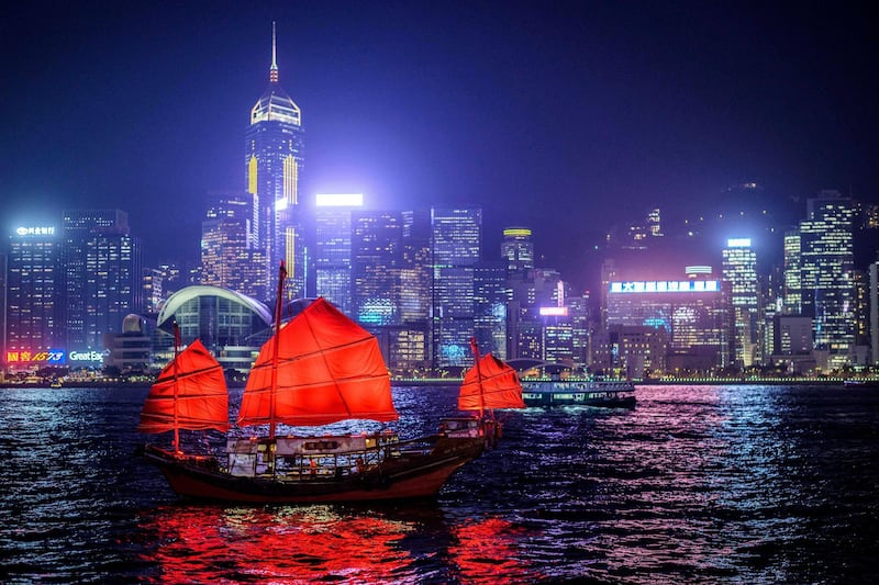 In this picture taken on November 27, 2020, a traditional wooden tourist junk boat "Dukling" sails in the waters of Victoria Harbour in Hong Kong, which was built in 1955 in neighbouring Macau and is the city's only authentic junk left -- with the other remaining vessels being modern replicas. - The wooden ship has been docked after new measures to stem a fourth wave of the coronavirus were introduced earlier this month, threatening the city's last remaining antique junk. (Photo by Anthony WALLACE / AFP)