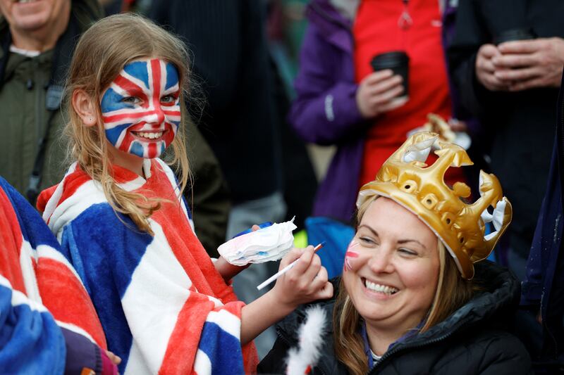 People enter the festive spirit as they wait to watch King Charles's coronation procession on The Mall in London. Rueters