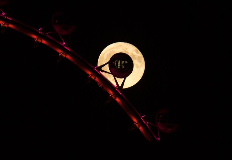 A full moon rises behind the High Roller observation wheel on the Strip in Las Vegas. Richard Brian / AP Photo