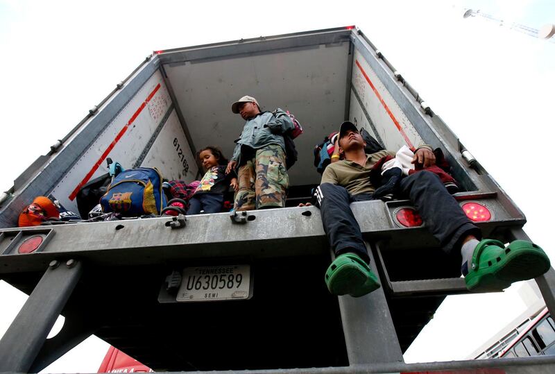 Central American migrants descend from a truck to be taken to a shelter, in the outskirts of Zapotlanejo, Jalisco state, Mexico. AFP
