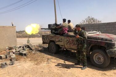 Members of GNA forces fire during a fight with Eastern forces, in southern Tripoli in June. Reuters