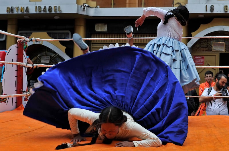 Cholita fighters perform in their signature outfit of pleated skirt, shawl and bowler hat – though this may be understandably discarded during a bout – with pigtail braids.  AFP