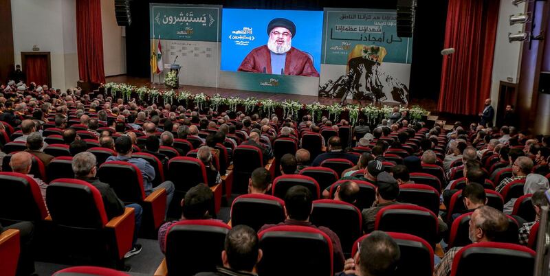 epa07155721 Lebanese supporter of Hezbollah listen to the speech of Hezbollah leader Sayyed Hassan Nasrallah on a giant screen, during a ceremony to mark the party's Martyrs Day at the hall of martyr Sayyed Mohammad Baker Al-Sadr at Al Mahdi school in Al-Hadath, southern suburb of Beirut, Lebanon, 10 November 2018. Secretary-General of Hezbollah, Sayyed Hassan Nasrallah delivered a speech, Where he talked about the political situation and the military conflicts in the Arab countries, and then touched on the Lebanese situation and political disputes between the Lebanese parties that disrupts the formation of a new government after the parliamentary elections.  EPA/NABIL MOUNZER