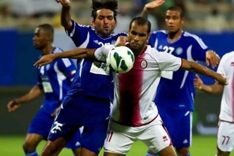 Saeed Al Kathiri, in white, was the hero of the night by scoring twice for Al Wahda against Al Nasr tonight. The Al Nasr players came in for criticism from their coach Walter Zenga for not fighting hard enough. Christopher Pike / The National
