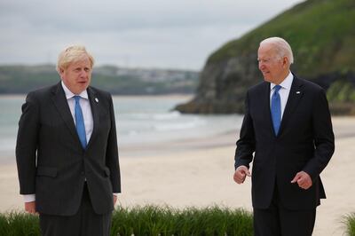 U.S. President Joe Biden, right, gestures to Boris Johnson, U.K. prime minister, as they arrive for the 'family photo' on the first day of the Group of Seven leaders summit in Carbis Bay, U.K., on Friday, June 11, 2021. U.K. prime minister Boris Johnson will give leaders a beachside welcome, formally kicking off three days of summitry along the English coast after meeting U.S. President Joe Biden for the first time on Thursday. Photographer: Hollie Adams/Bloomberg