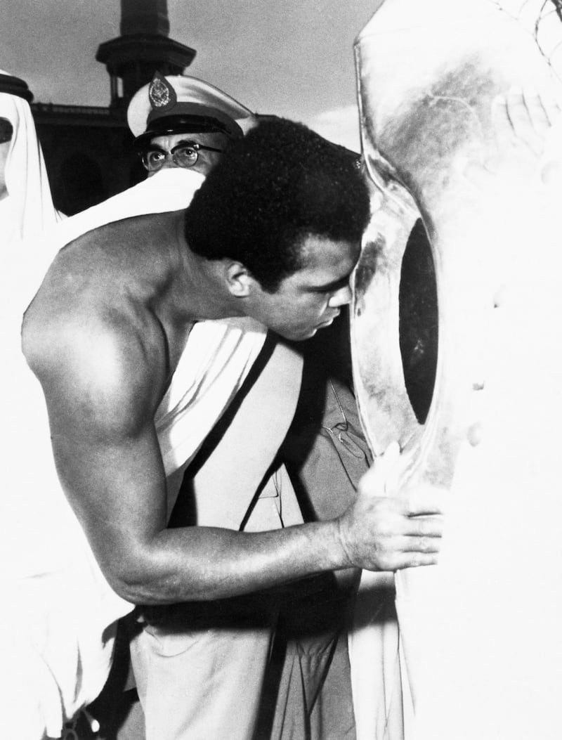 Former world heavyweight boxing champion Muhammad Ali kisses the Black Stone in the Kaaba while performing Hajj in 1972. Getty