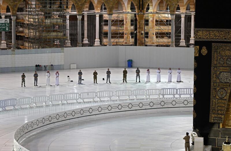 Worshipers perform Isha prayer while keeping distance between them next to the Kaaba in Mecca's Grand Mosque, Islam's holiest site. Saudi Authorities allowed for limit number of worshipers to enter the Grand mosque to perform prayers during the Islamic holy fasting month of Ramadan, amid unprecedented bans on family gatherings and mass prayers due to the coronavirus (COVID-19) pandemic.  AFP