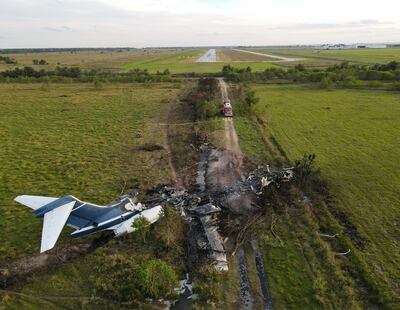 The remnants of an aircraft, which caught fire soon after a failed take-off attempt at Houston Executive Airport. Houston Chronicle via AP