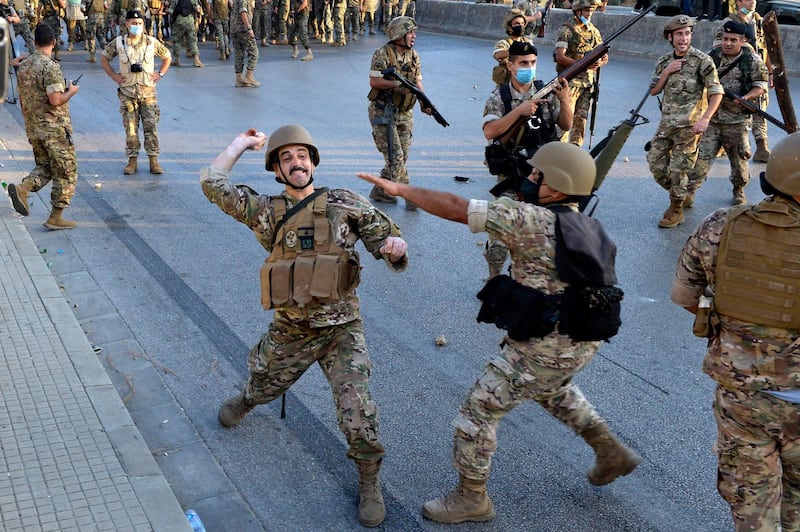 A Lebanese army soldier throw stones at anti-government protesters during a protest on the road leading to the Presidential palace in Baabda, east Beirut.  EPA