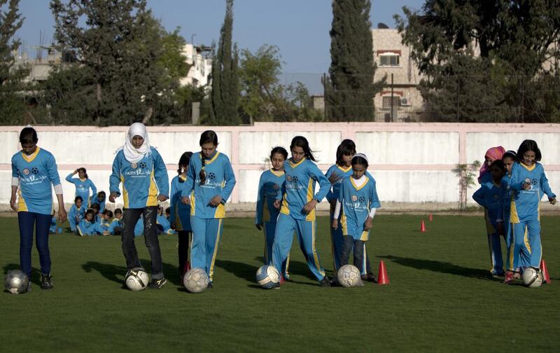 Palestinian girls tarining at the Beit Lahia football club in the northern Gaza strip as part of an after-school sport program funded by the Palestine Association for Children’s Encouragement of Sports. Mahmud Hams / AFP 

