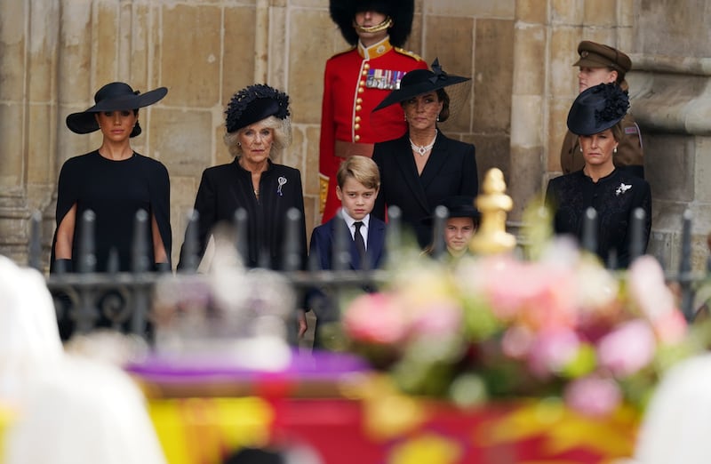 Meghan, Duchess of Sussex, Queen Consort Camilla, Prince George, Catherine, Princess of Wales, Princess Charlotte and Sophie, Countess of Wessex, stand outside Westminster Abbey after the funeral. PA