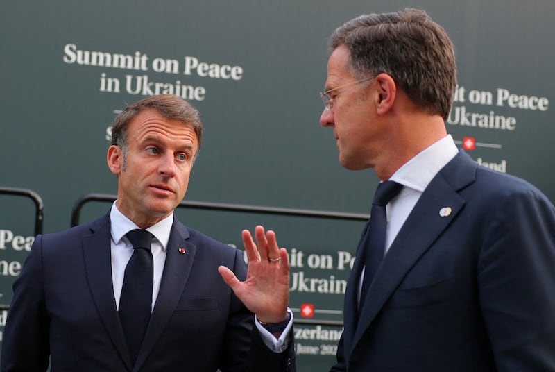 French President Emmanuel Macron speaks with Dutch Prime Minister Mark Rutte. Reuters