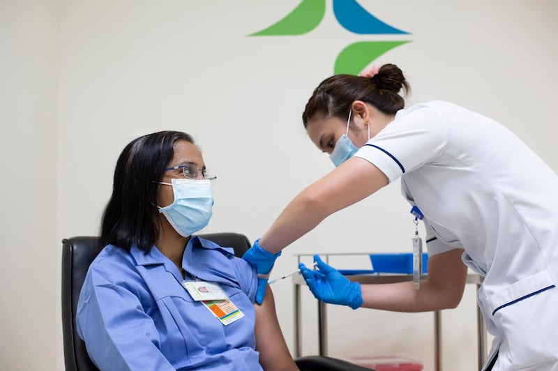 Asha Susan Philip, a 45-year-old nurse with Dubai Health Authority, receives the Pfizer vaccine.