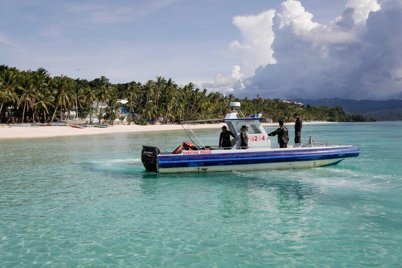 Maritime police on patrol on the first day of a test-run allowing tourists to return to Boracay. Photos by Mark R Cristano / EPA