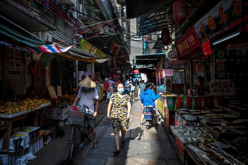 A woman walks through the wet market in Guangzhou, China. China races to contain a second wave of coronavirus cases mostly in Beijing.  EPA