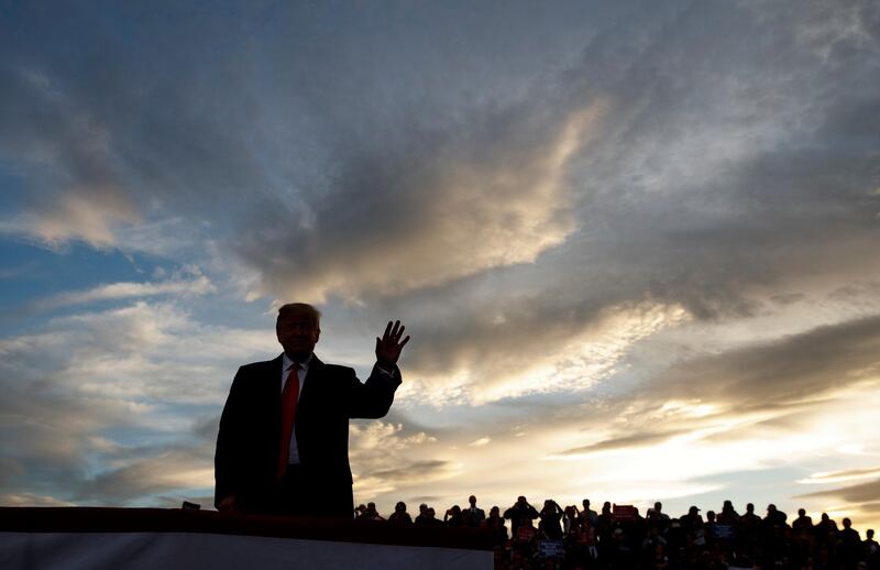 US President Donald Trump waves as he arrives to speak at a campaign rally in Missoula, Montana. Carolyn Kaster / AP Photo
