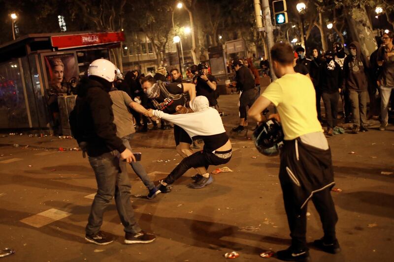 Pro-independence supporters scuffle with rioters trying to set up barricades on the street near a pro-independence demonstration in Barcelona, Spain. AP Photo