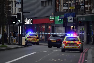 Police attend the scene after an incident in Streatham, London, Sunday Feb. 2, 2020. London police say officers shot a man during a “terrorism-related incident” that involved the stabbings of “a number of people.” (Kirsty O'Connor/PA via AP)