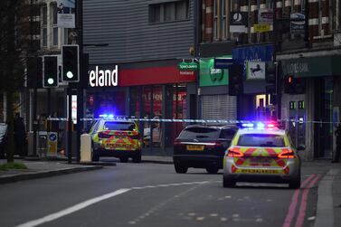 Police attend the scene after an incident in Streatham, London, Sunday Feb. 2, 2020. London police say officers shot a man during a “terrorism-related incident” that involved the stabbings of “a number of people.” (Kirsty O'Connor/PA via AP)