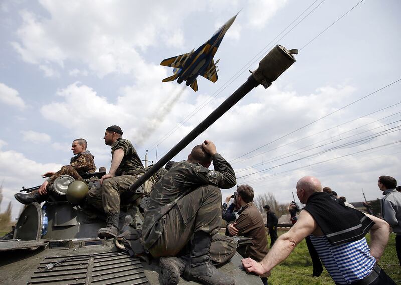 In this 2014 photo, Ukrainian soldiers sit on an armoured personnel carrier in Kramatorsk. Ukrainian government forces and separatist pro-Russian militia staged rival shows of force in eastern Ukraine. Reuters