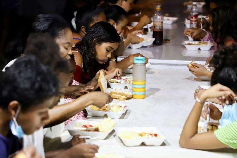 People eat a Christmas dinner of donated food at a shelter in Tapachula, Mexico. Reuters