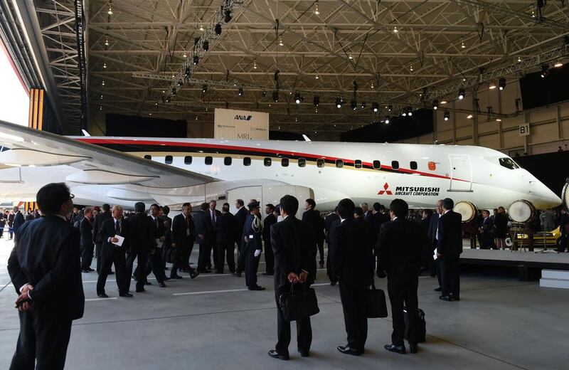 Guests look at a Mitsubishi Regional Jet during the ceremony at the Nagoya airport in Komaki. Toshifumi Kitamura / AFP