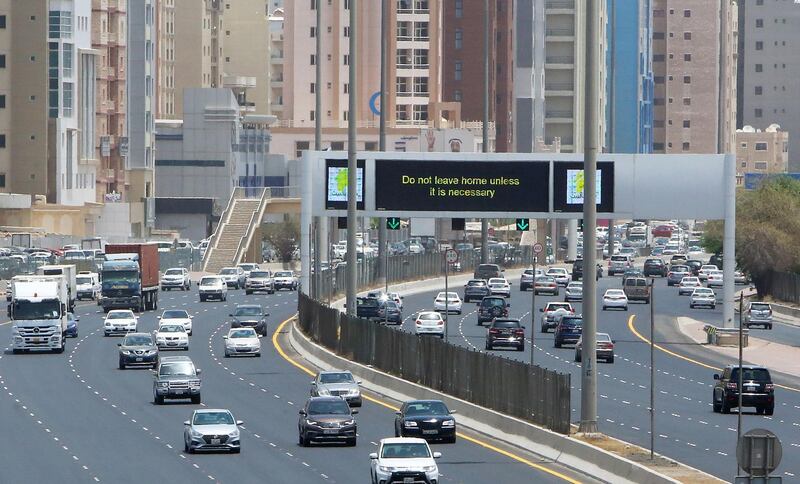 A sign reminds residents to remain vigilant, as they drive along a motorway in Kuwait City.   AFP