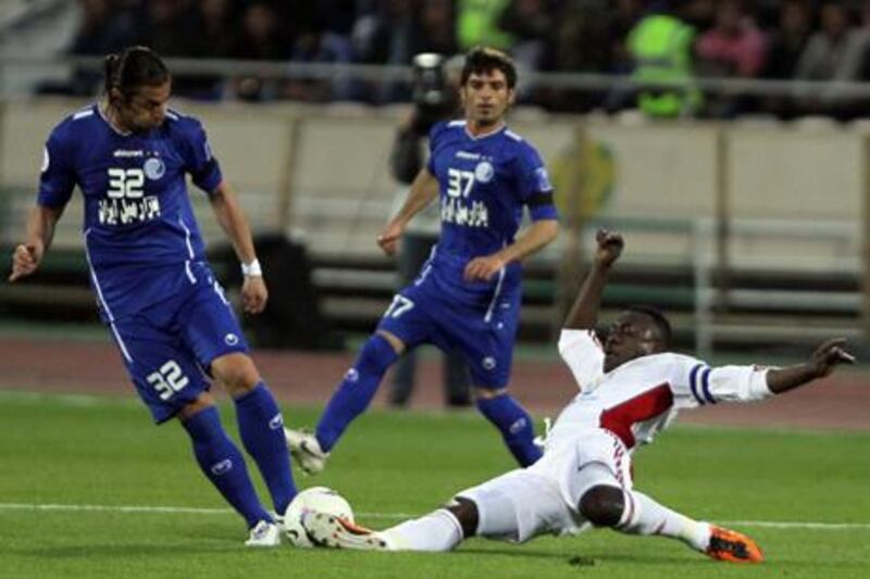 Ferdoon Zandi of Esteghlal is challenged by Al Jazira's Ibrahim Diaky during their 2012 Champions League clash.