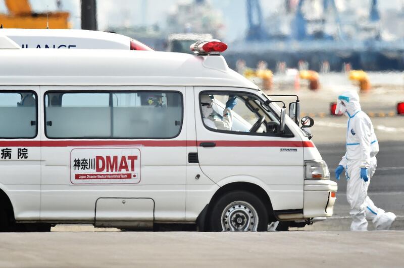 Personnel clad in protective gear and tasked to provide care for suspected patients on board the Diamond Princess cruise ship prepare to carry-out an evacuation at the Daikoku Pier Cruise Terminal in Yokohama, as over 3,700 people remain quarantined onboard due to fears of the new coronavirus.  AFP