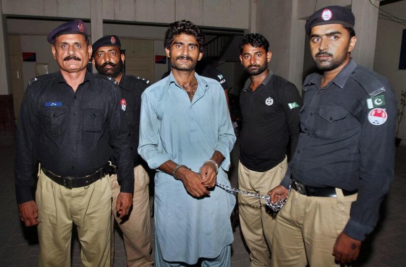 Pakistani police officers present Waseem Azeem, the brother of slain model Qandeel Baloch, before the media following his arrest at a police station in Multan, Pakistan on July 17, 2016. Before being led away, he said he was 'not embarrassed' to have killed her. AP Photo/Asim Tanveer