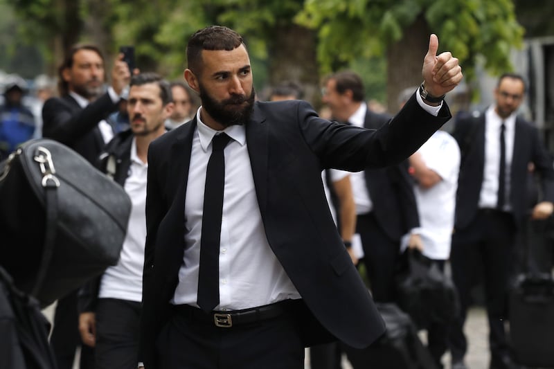 Real Madrid's striker Karim Benzema greets the fans as he arrives at the club's hotel in Chantilly. EPA