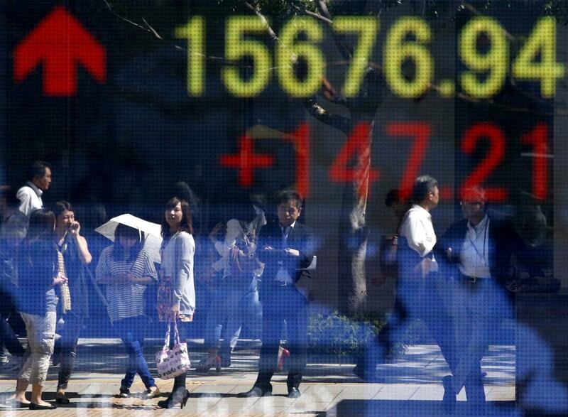 Global markets rose after the US Federal Reserve delayed plans to cut back its asset-buying programme. In Tokyo, above, the Nikkei closed 1.80 per cent higher. Toru Hanai / Reuters