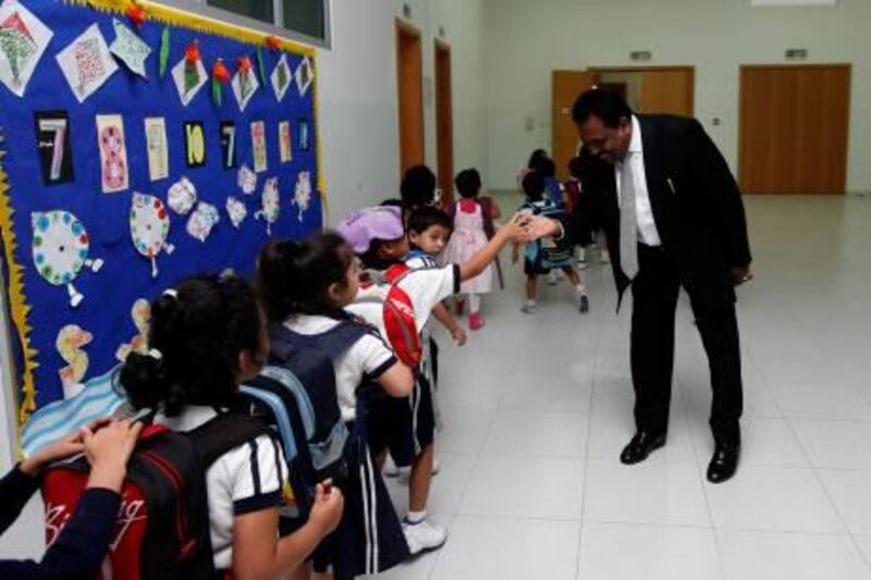 Dubai, 24th February 2011.  Kindergarten pupils leaving after their class as they were met by their school's principal Mr Anthony Joseph, in JSS International School.  (Jeffrey E Biteng / The National)