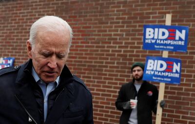 A supporter for Democratic 2020 U.S. presidential candidate and former Vice President Joe Biden holds a sign as Biden leaves a polling station after a visit, on the day of New Hampshire's first-in-the-nation primary in Manchester, New Hampshire, U.S., February 11, 2020. REUTERS/Carlos Barria