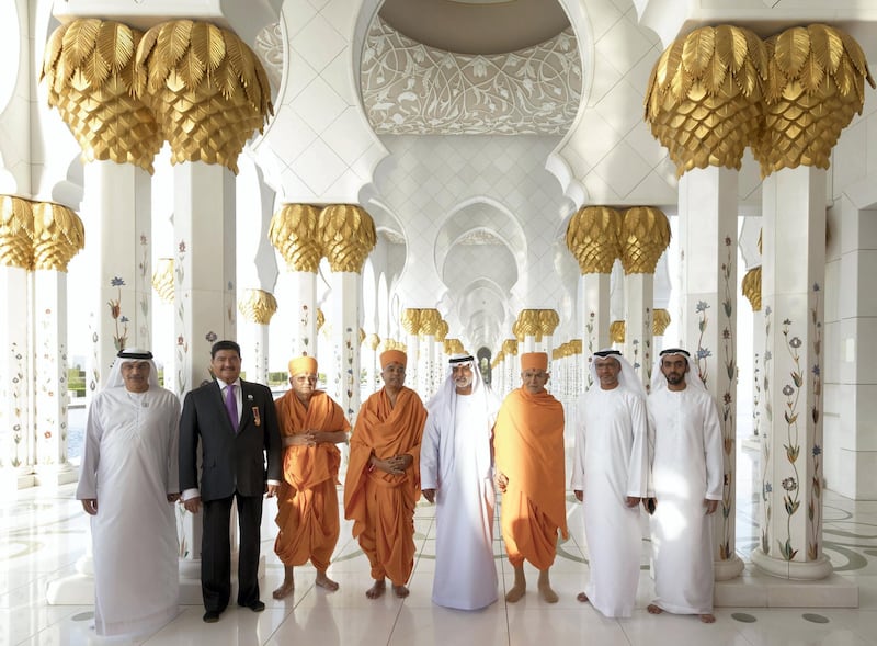 Mahant Swami Maharaj and Sheikh Nahyan and others in the corridor of 1,096 pillars