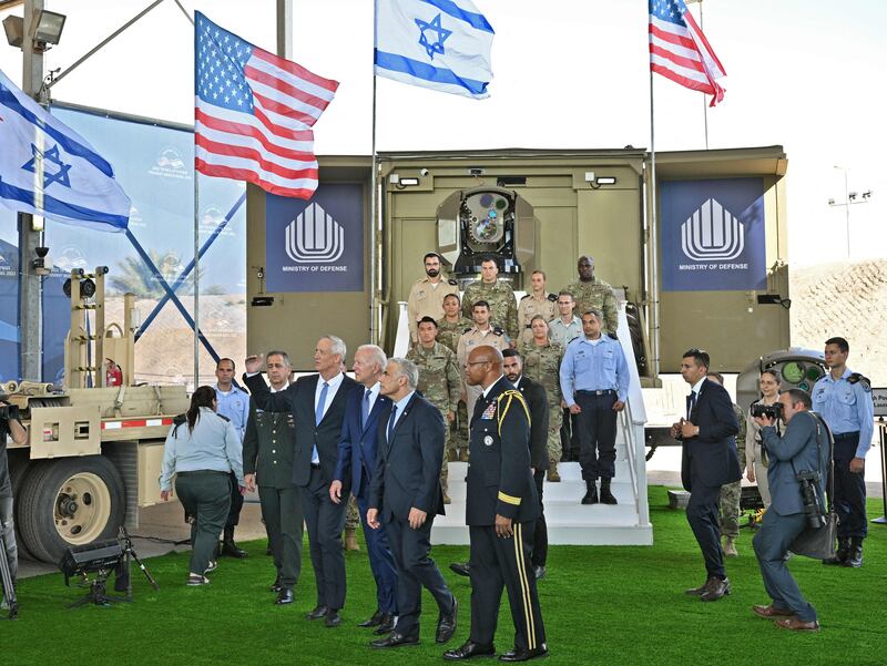 Mr Biden walks with Israeli Defence Minister Benny Gantz, Mr Yair Lapid  and US Defence Attache in Israel Brig Gen Shawn Harris. AFP