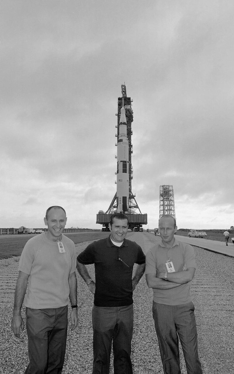 Alan Bean is seen with fellow Apollo 12 moon mission crewmen in front of their Saturn 5 space vehicle as the rocket was rolled out of the VAB at Cape Kennedy Sept. 8, 1969 toward launch pad at complex 39. From left are Lunar Module Pilot Alan Bean; Command Module Pilot Richard Gordon and Commander Charles Conrad. Jim Bourdier / AP Photo